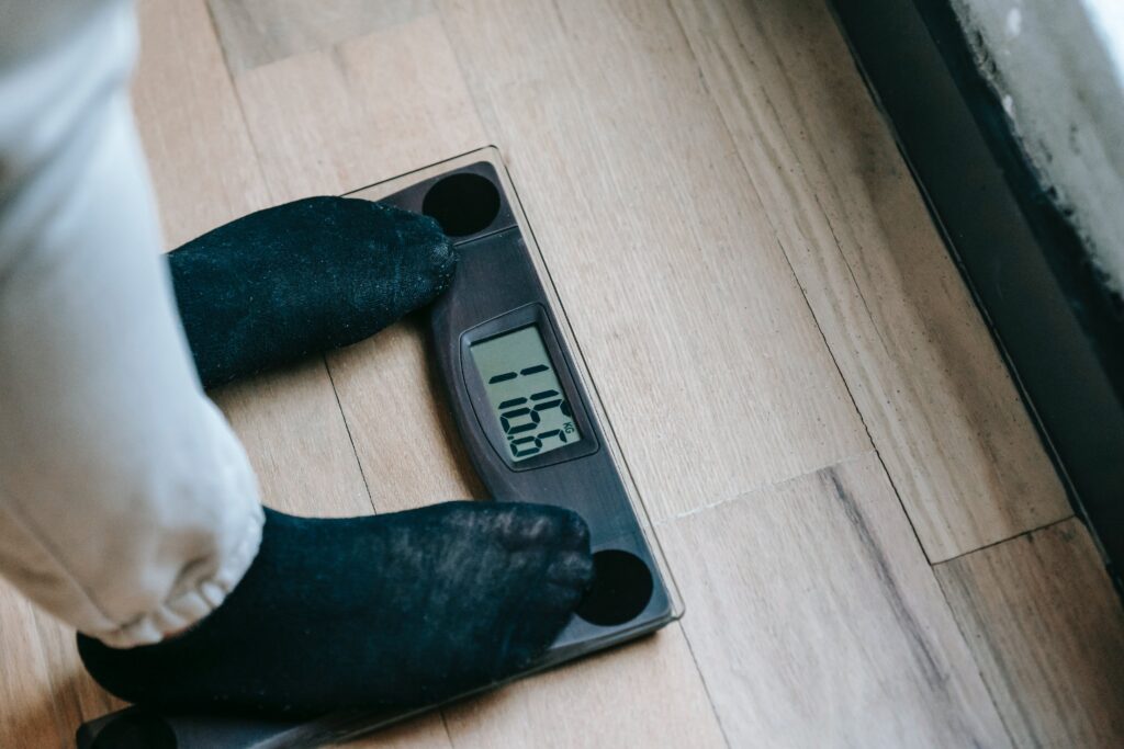 Women measuring her weight - weight loss.